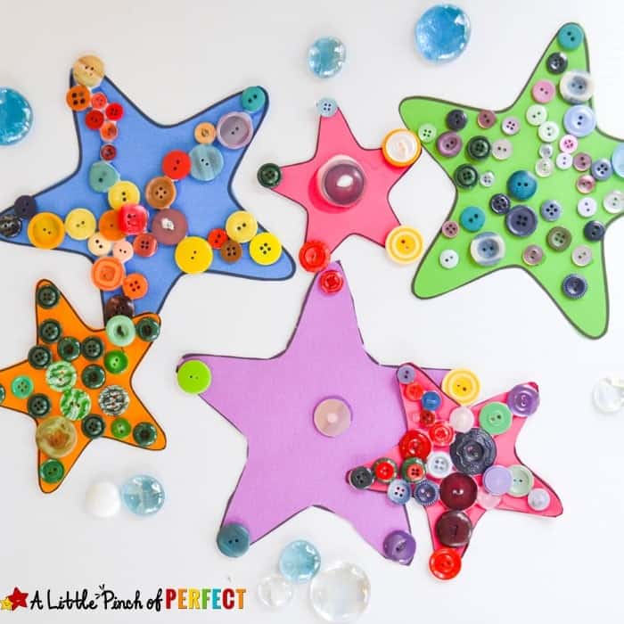 Five colorful foam starfish crafts decorated with assorted buttons and glass gems on a white surface