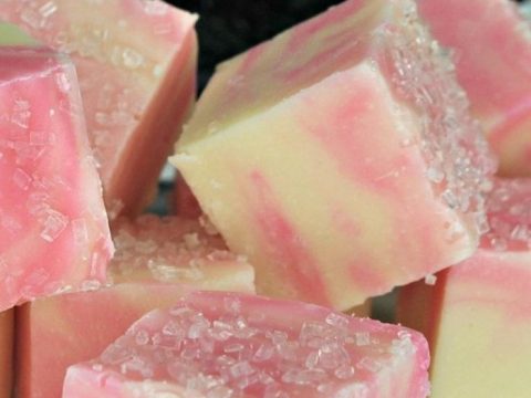Pink and white swirled cotton candy fudge squares with sparkling sugar crystals — a dreamy sugar plum fairy party food treat that looks as magical as it tastes.