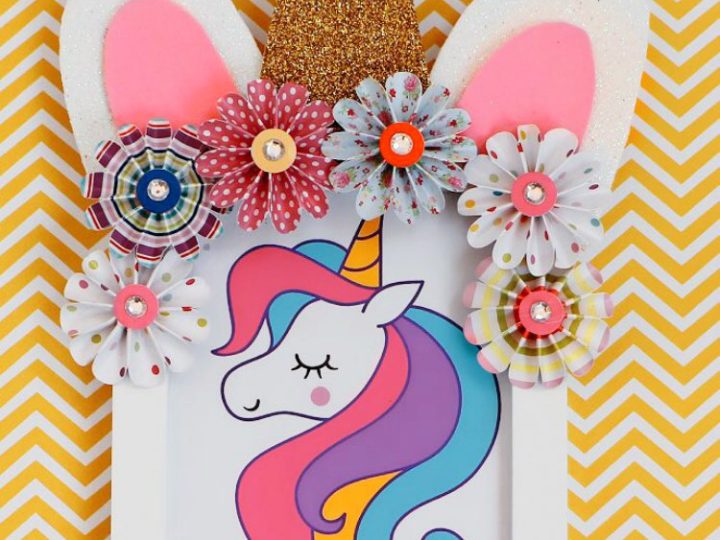 A DIY unicorn photo frame with a glitter horn foam ears and paper flowers is a charming unicorn party craft and activity