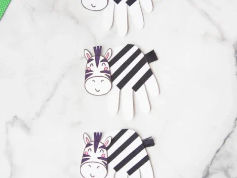 Cute handprint zebra crafts with black and white stripes for safari party crafts and activities