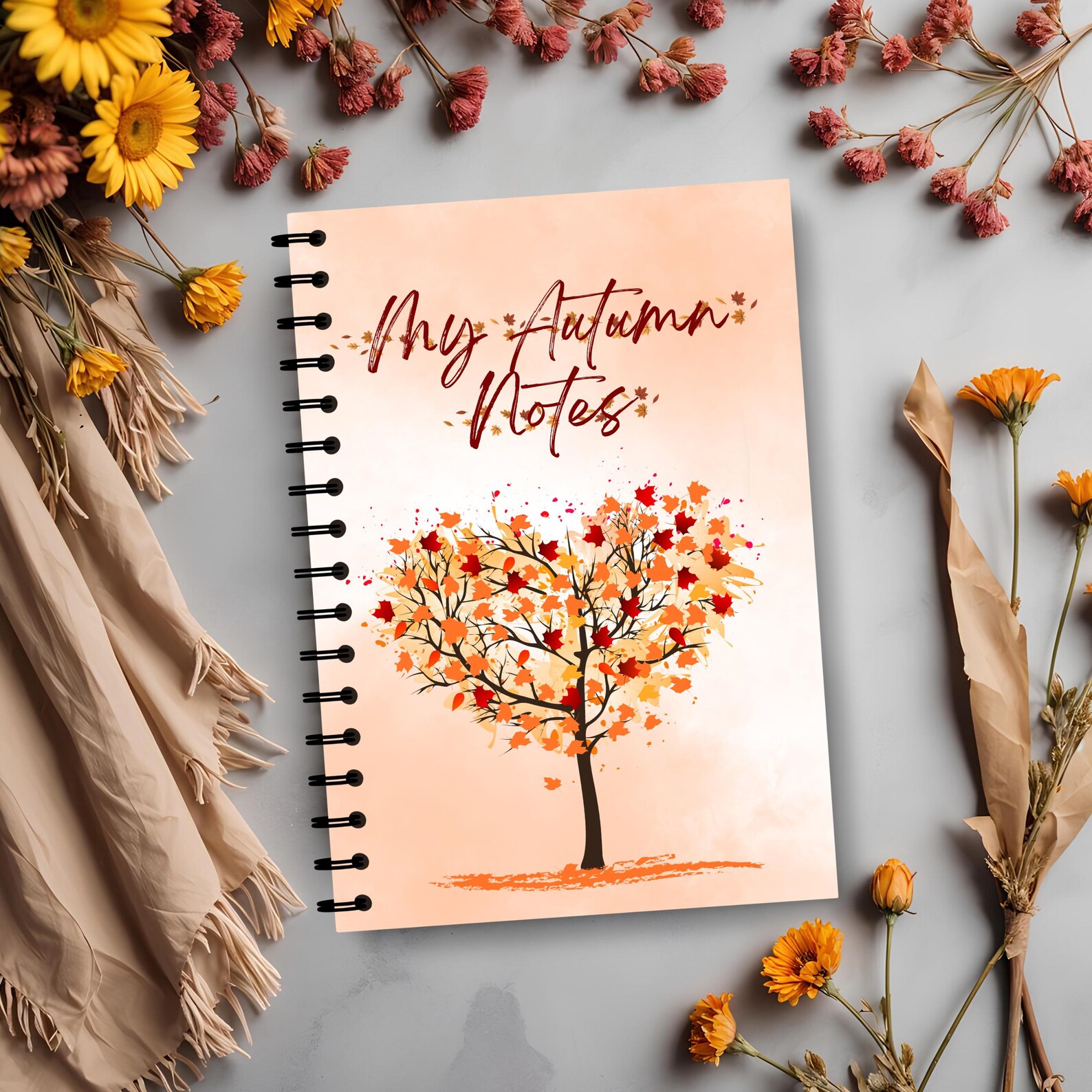 Spiral-bound 'My Autumn Notes' journal with a colorful fall tree design surrounded by dried flowers — a sweet Thanksgiving hostess gift idea.