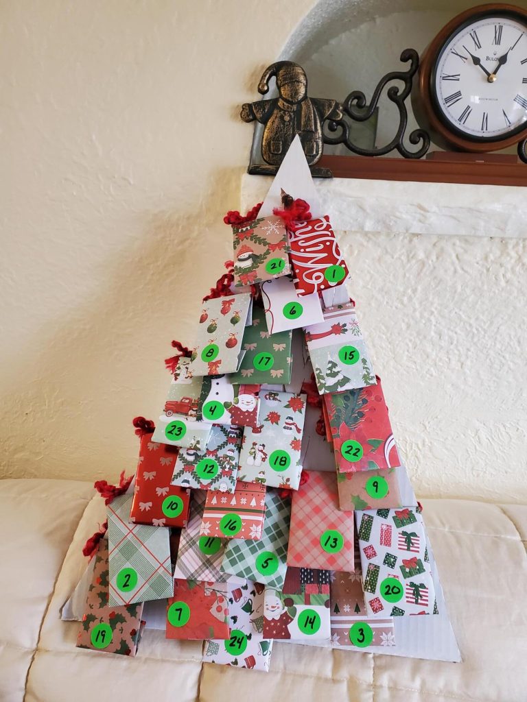 Numbered Christmas tree-shaped advent calendar made of festive wrapped packages 1 through 24 — a whimsical and creative tea advent calendar for the holiday season.