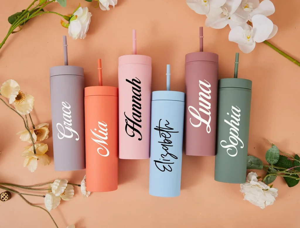 Six custom name matte tumblers with straws in pastel colors including lavender, coral, pink, blue, mauve, and sage, stylish pool party favors.