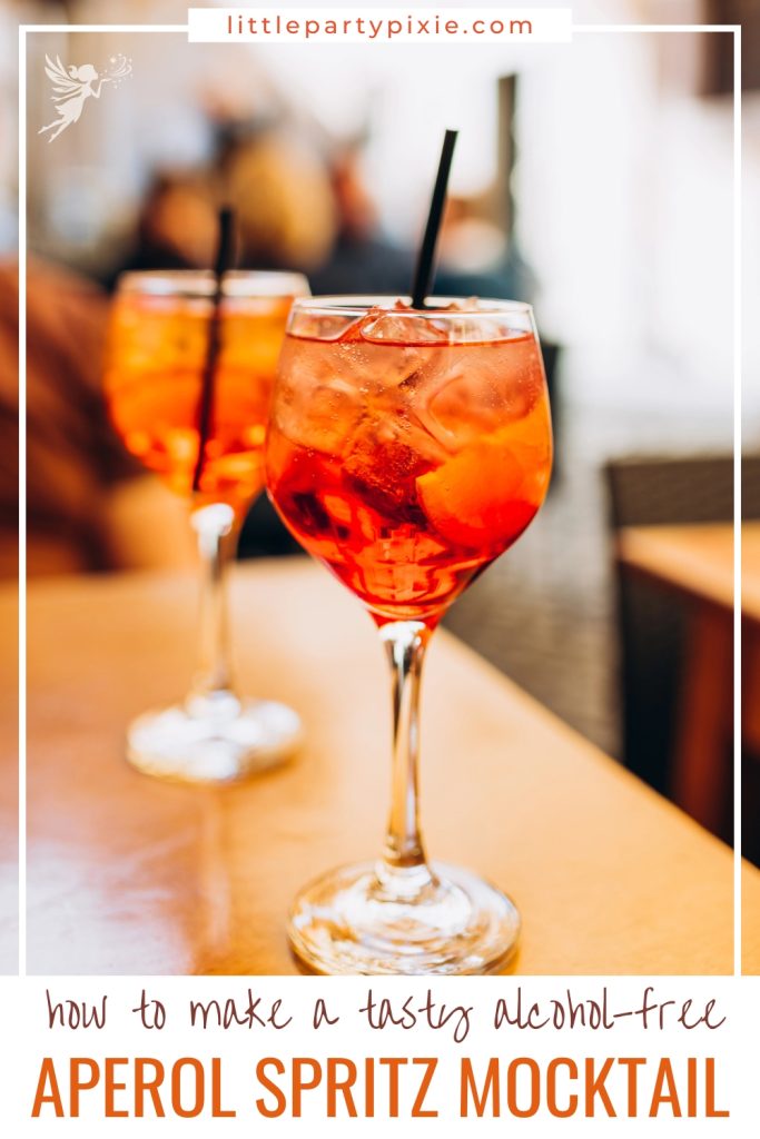 close up of two glasses of Aperol served in tall wine glasses with clack straws. text overaly how to make a tasty alcohol free Aperol spritz mocktail