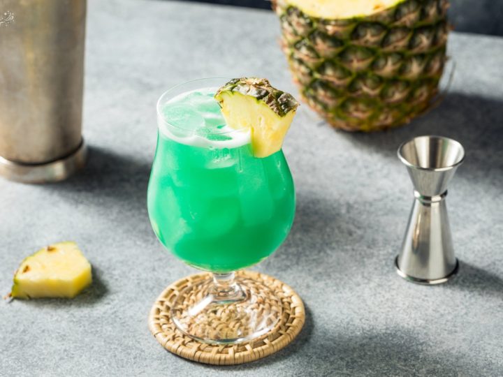 Blue lagoon mocktail glass with pineapple garnish