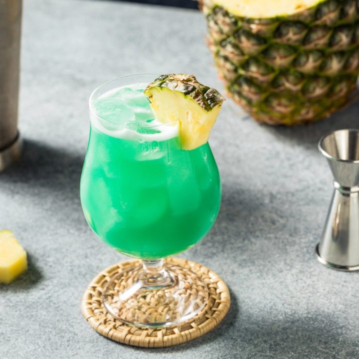 Blue lagoon mocktail glass with pineapple garnish