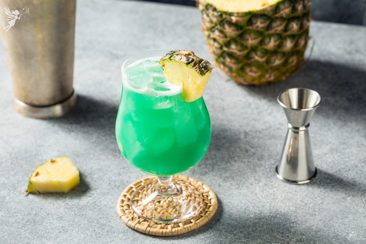 Blue lagoon mocktail glass with pineapple garnish