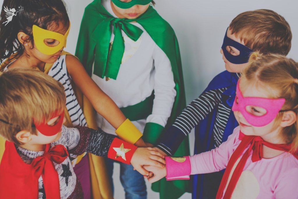 girls and boys at a party dressed in superherro costumes
