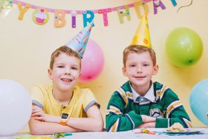 two boys in party hats small birthday party
