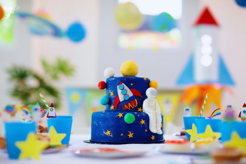 space birthday cake with bright colorful party set up