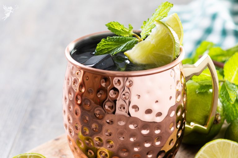 close up of a moscow mule copper mug with lime slice and mint