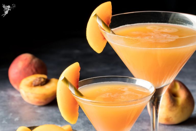 close up the top of two glasses of beach bellini with peach slices