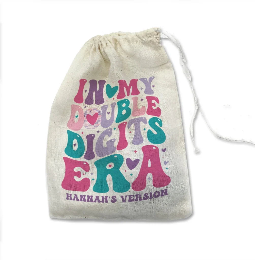 Natural cotton drawstring bag printed with bold colorful "In My Double Digits Era — Hannah's Version" retro lettering — a trendy and hilarious choice for tween girl party favors.