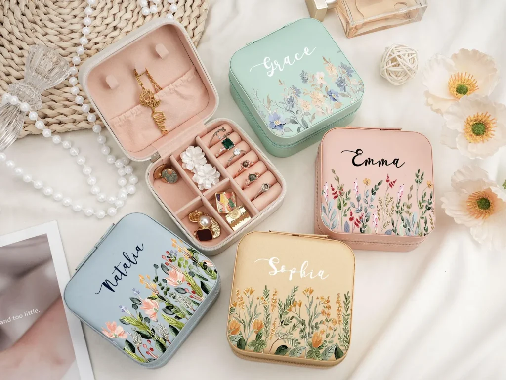 Personalized floral jewelry boxes in mint, pink, blue, and gold with compartments for rings, earrings, and necklaces — gorgeous tween girl party favors.