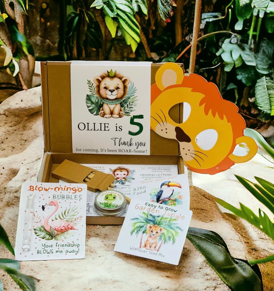Safari animals party favor ideas showcasing a personalized activity box for "Ollie is 5" containing a lion mask, bubbles, wildflower seeds, crocodile eggs, activity sheets, and pencils.
