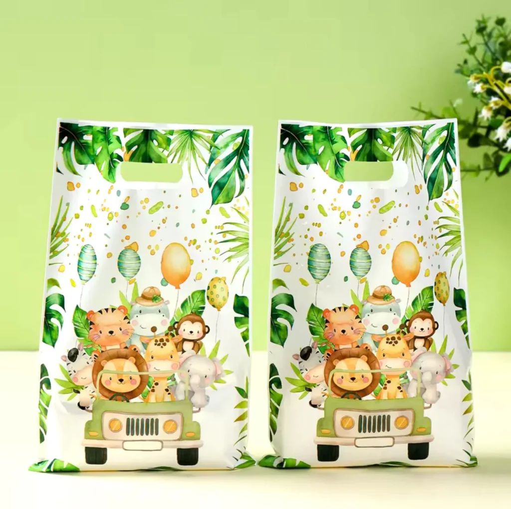 Safari animals party favor ideas showcasing white plastic goodie bags printed with cartoon safari animals riding a jungle jeep surrounded by tropical monstera leaves.