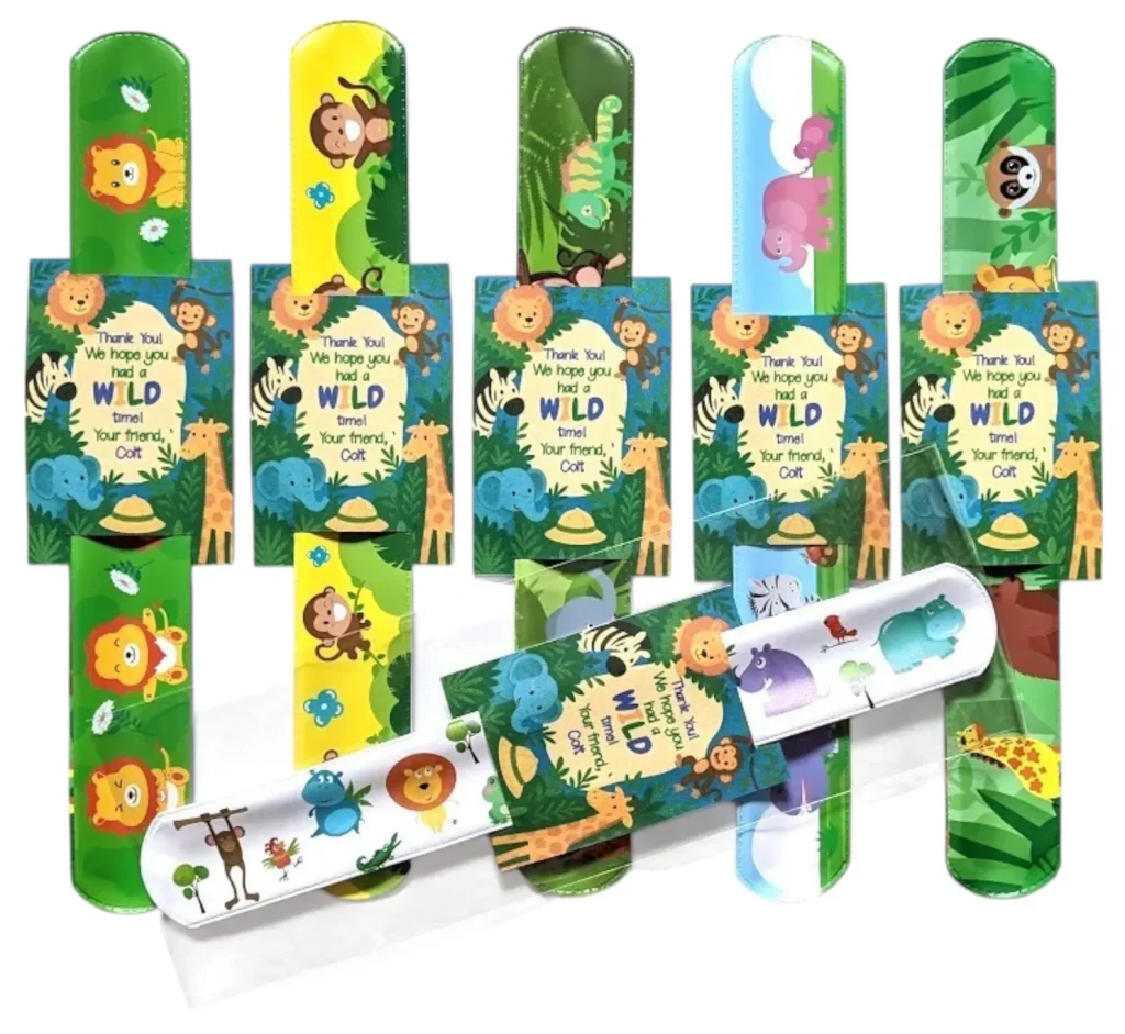 Safari animals party favor ideas featuring colorful slap bracelets with jungle animal prints, personalized thank you cards reading "We hope you had a WILD time!"