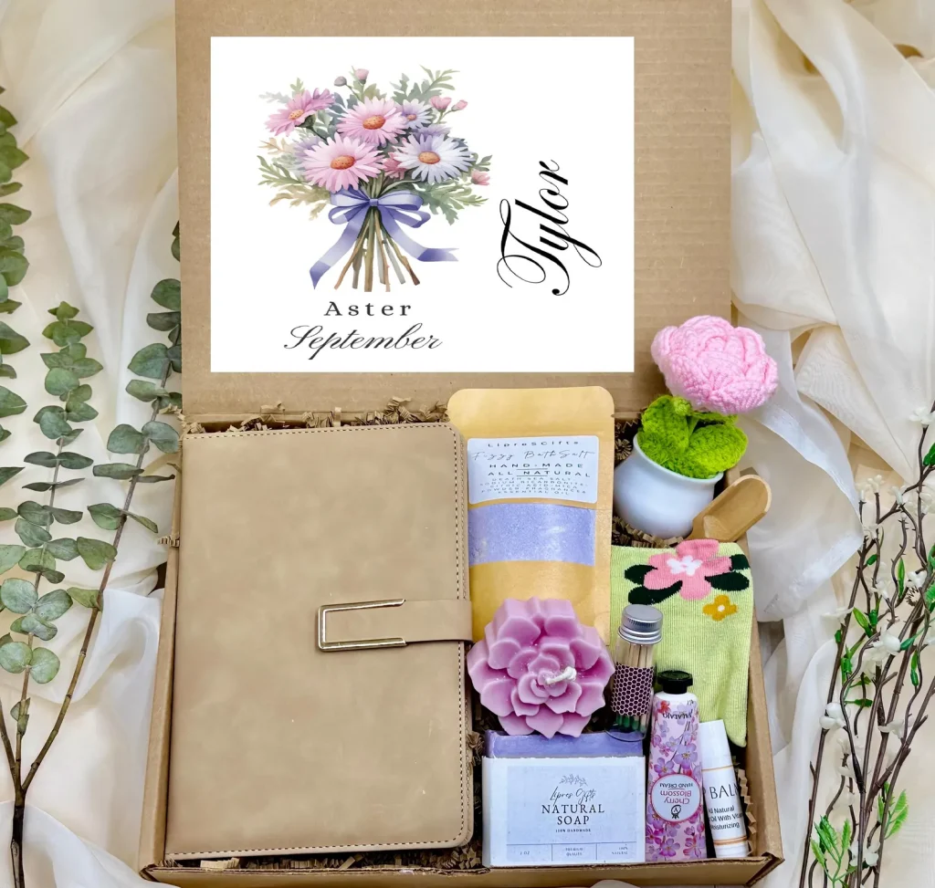Aster-themed gift box with a journal, candle, soap, and hand cream, a pampering set of September birthday gift ideas.
