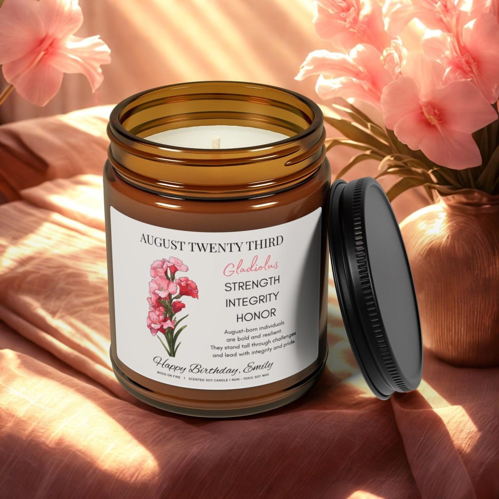 A personalized amber jar soy candle with a gladiolus birth flower label and a custom birthday name and date, a heartfelt and aromatic August birthday gift idea.