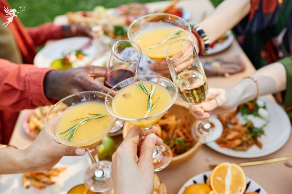 toasting a fall brunch cocktail glasses orange