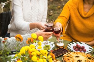 friends toasting red wine glasses