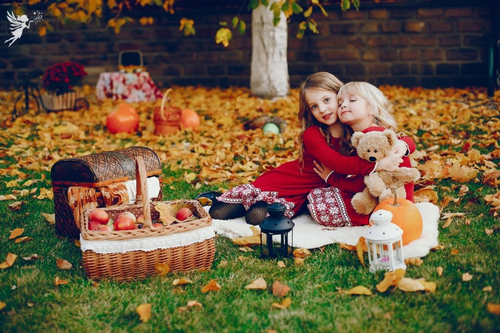 fall outdoor picnic party for two girls with a hamper of apples