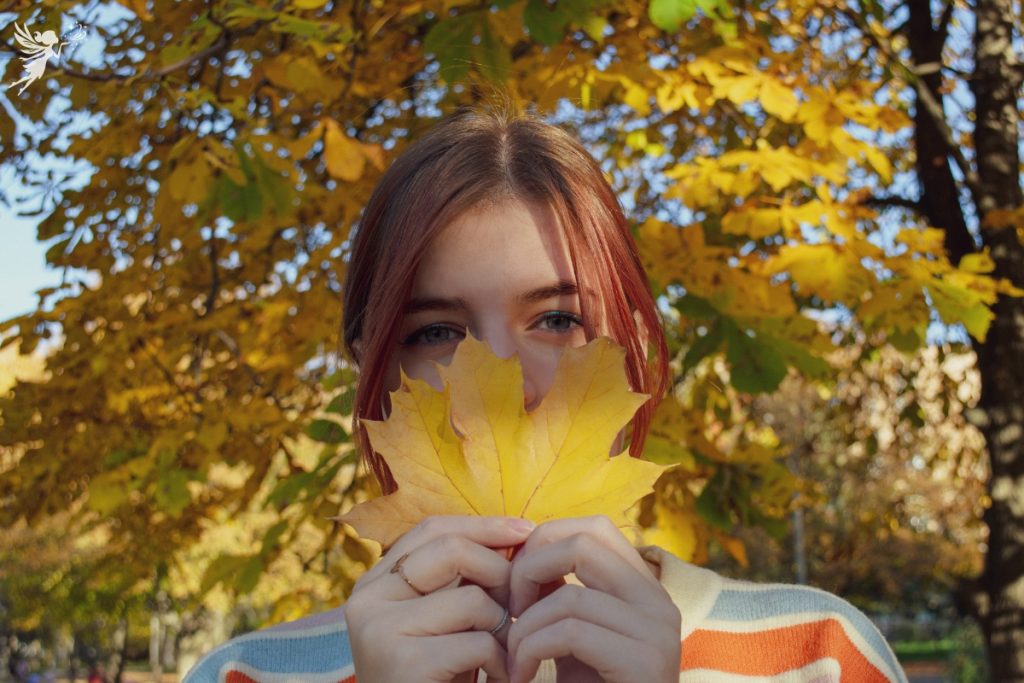 aesthetic teen girl holding fall leaf