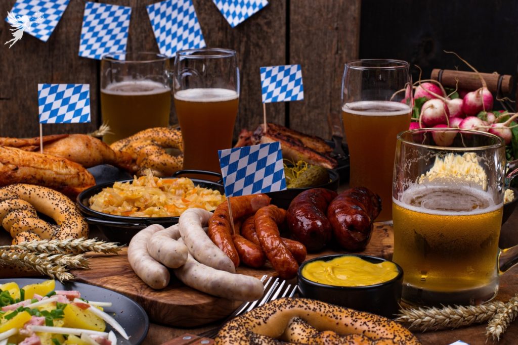 oktoberfest themed party food table with bratwurst and pretzels beer