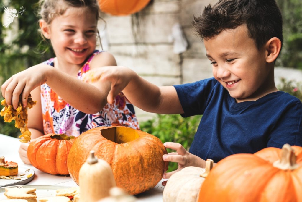 children doing pumpkin carving fall party