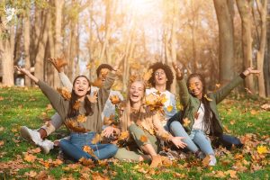 teens happy leaves in the fall