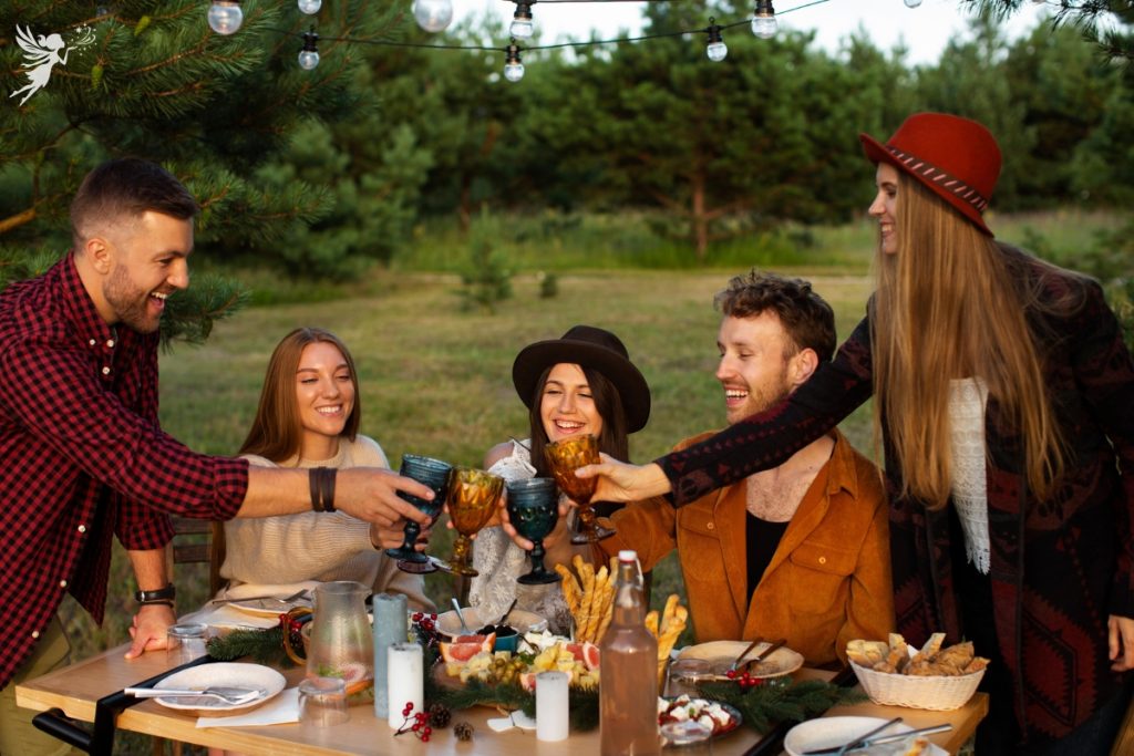 friends enjoying a wine and cheese harvest meal