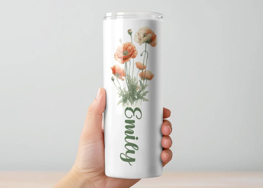 A slim white insulated tumbler printed with a watercolor peach poppy bouquet and a personalized name in script, a pretty and practical August birthday gift idea.