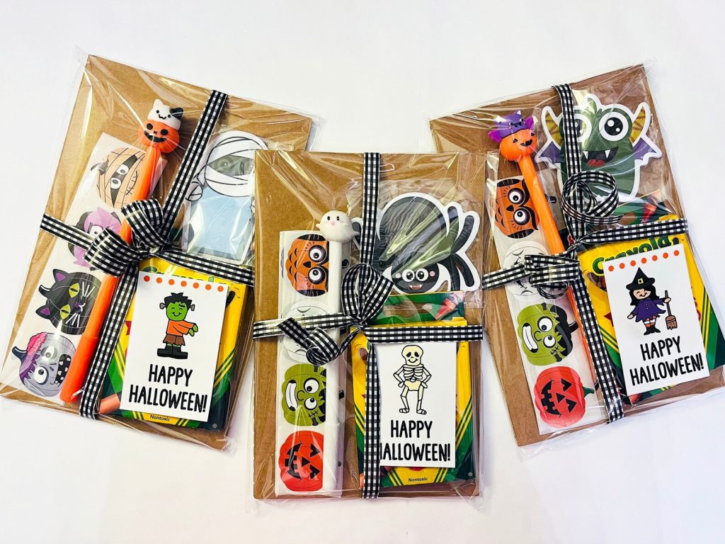 Premade Halloween party favor bags with crayons, stickers, and character pens tied with gingham ribbon, ready-to-go Halloween party favors.