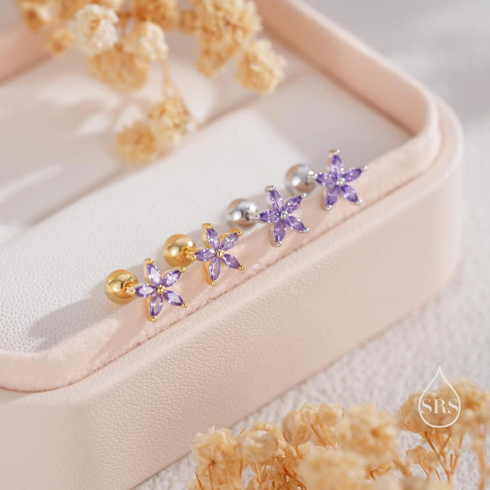 Two pairs of delicate flower stud earrings set with marquise purple amethyst crystals in gold and silver, a dainty February birthday gift idea.