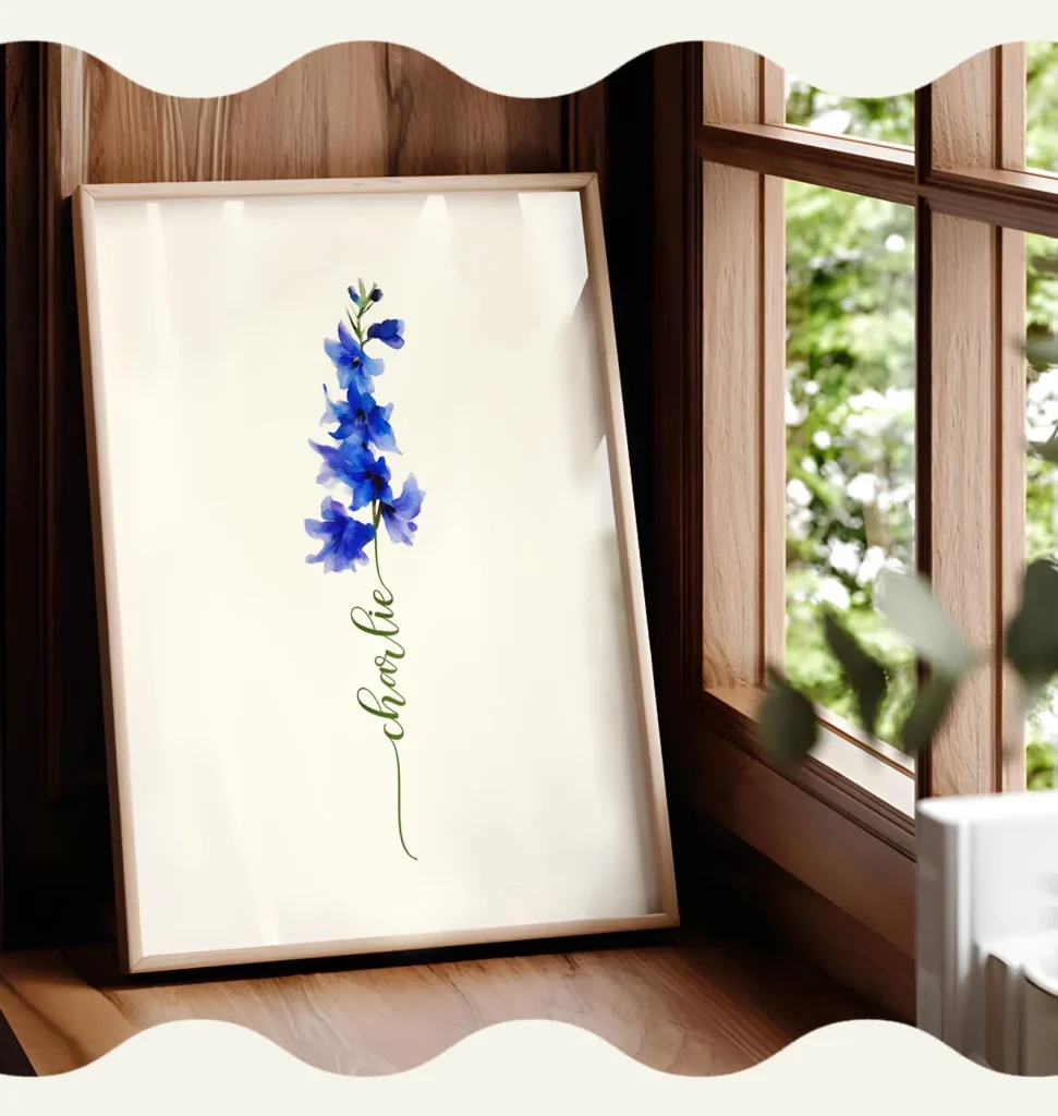 A framed watercolor art print featuring a single blue larkspur stem with a personalized name in flowing calligraphy, a delicate and meaningful July birthday gift idea.