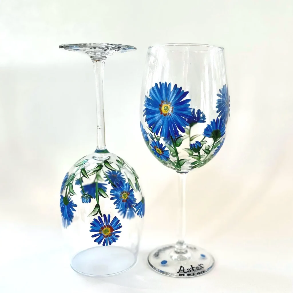 Hand-painted wine glasses with vibrant blue aster flowers, an elegant option for September birthday gift ideas.