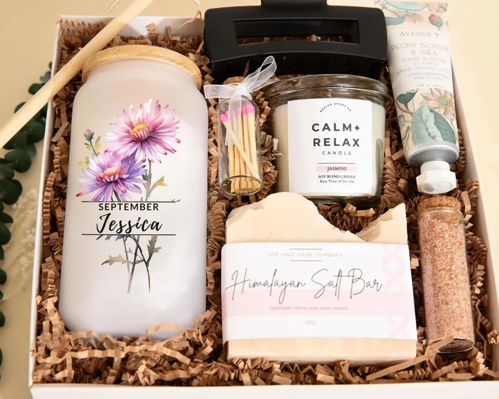 Personalized aster-themed self-care gift box with a candle, soap, lotion, and bath salts, a pampering set of September birthday gift ideas.