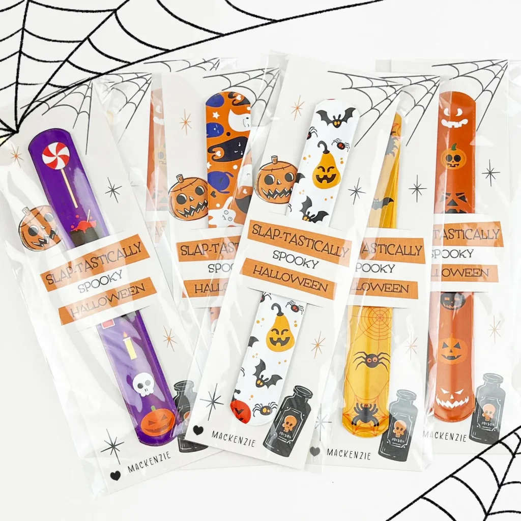 Halloween-themed slap bracelets with pumpkin, bat, and spider prints, fun "slap-tastically spooky" Halloween party favors for kids.