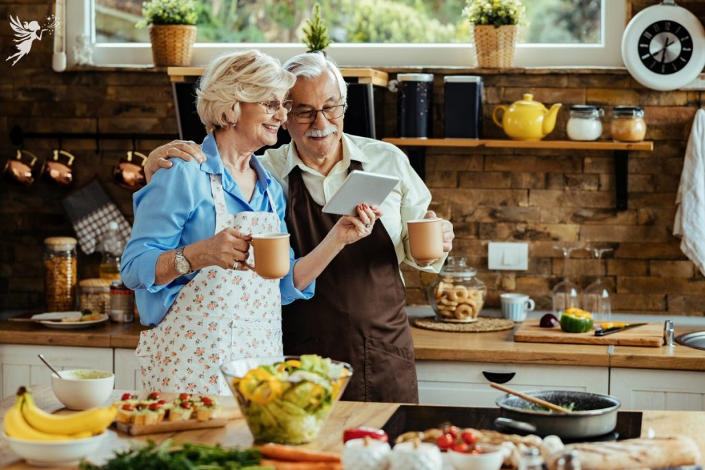 grandparents baking together while chatting online tablet