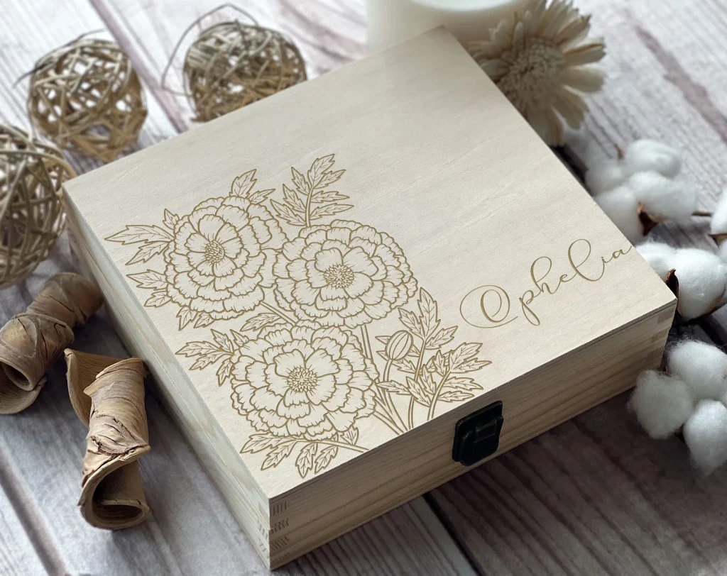 A laser engraved wooden keepsake box featuring a detailed marigold floral design with a personalized name, one of the most elegant October birthday gift ideas.
