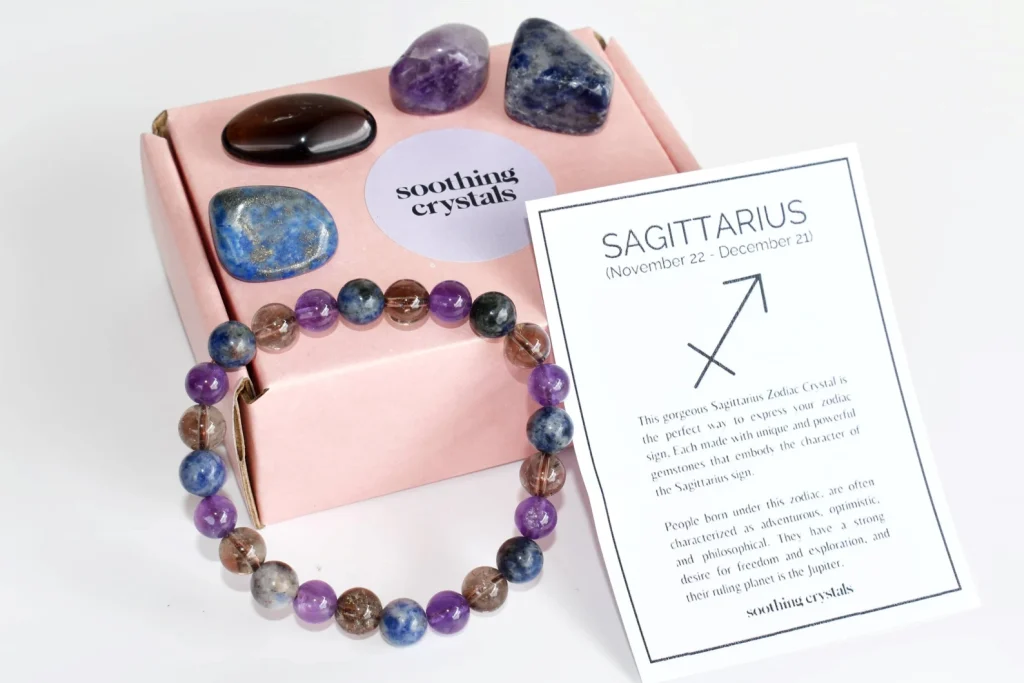 A Sagittarius crystal gift set in a pink box including amethyst, sodalite and smoky quartz tumbled stones with a matching beaded bracelet, a perfect November birthday gift idea.