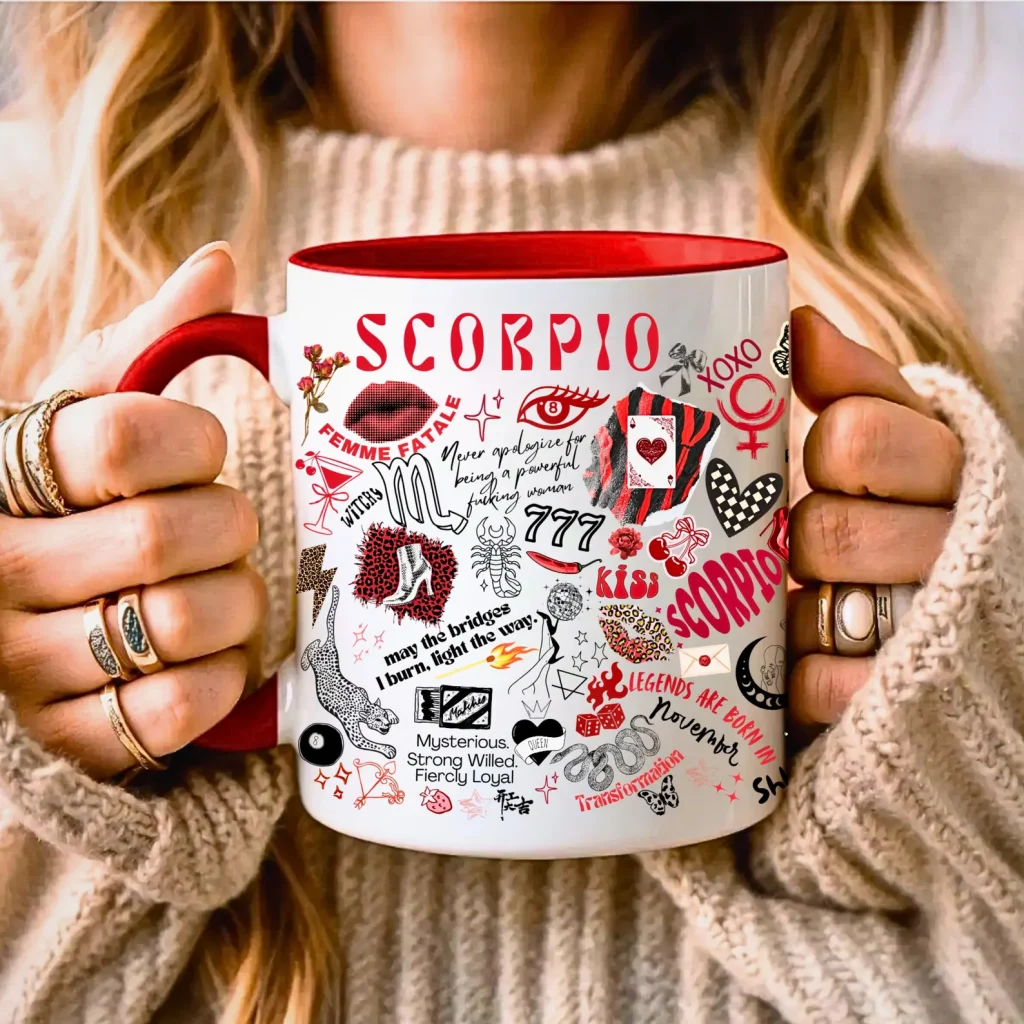 A woman holding a white and red Scorpio themed coffee mug covered in bold zodiac illustrations and personality traits, a fun November birthday gift idea.