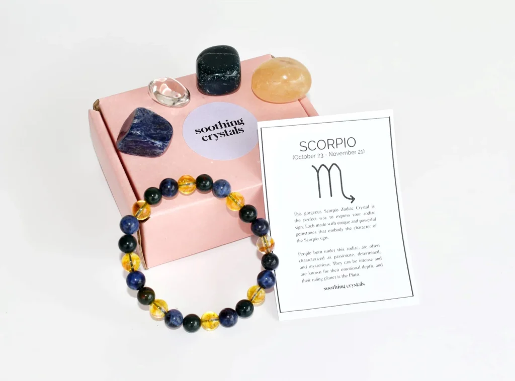 A Scorpio zodiac crystal gift set including tumbled gemstones in blue, black and amber tones with a beaded bracelet, among the most meaningful November birthday gift ideas.