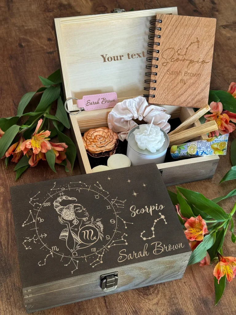 A personalized engraved wooden Scorpio gift box filled with a spiral journal, candle, satin scrunchie and palo santo, one of the most thoughtful November birthday gift ideas.