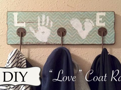 A wooden coat rack decorated with children's colorful handprints, making a sentimental homemade gift for grandparents.