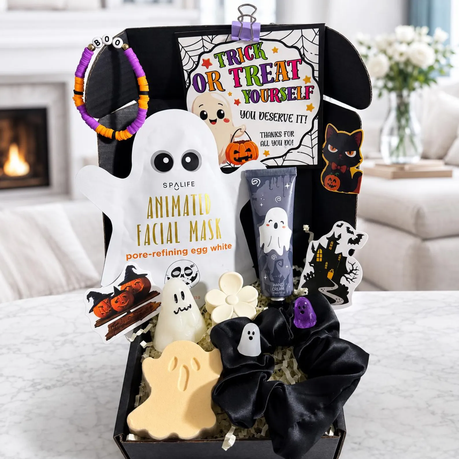 A spooky black gift box with ghost soaps, face mask, hand cream and scrunchie, perfect Halloween boo basket ideas for teens.