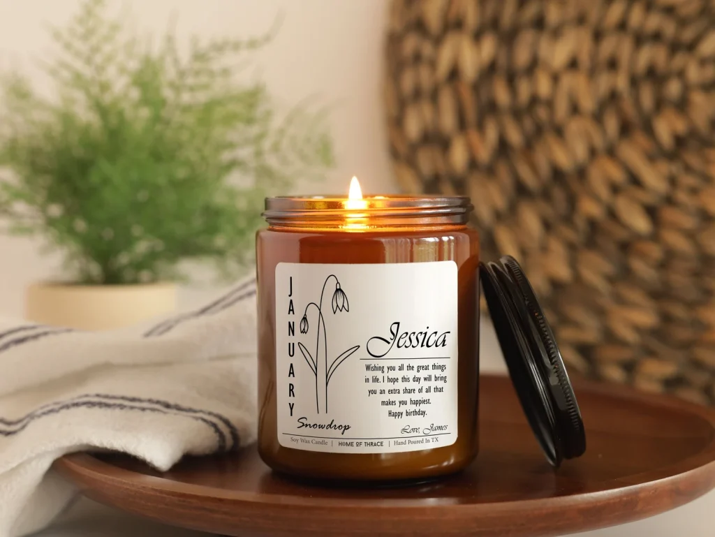 A personalized amber jar January snowdrop candle with a custom name and birthday message, a heartfelt January birthday gift idea.