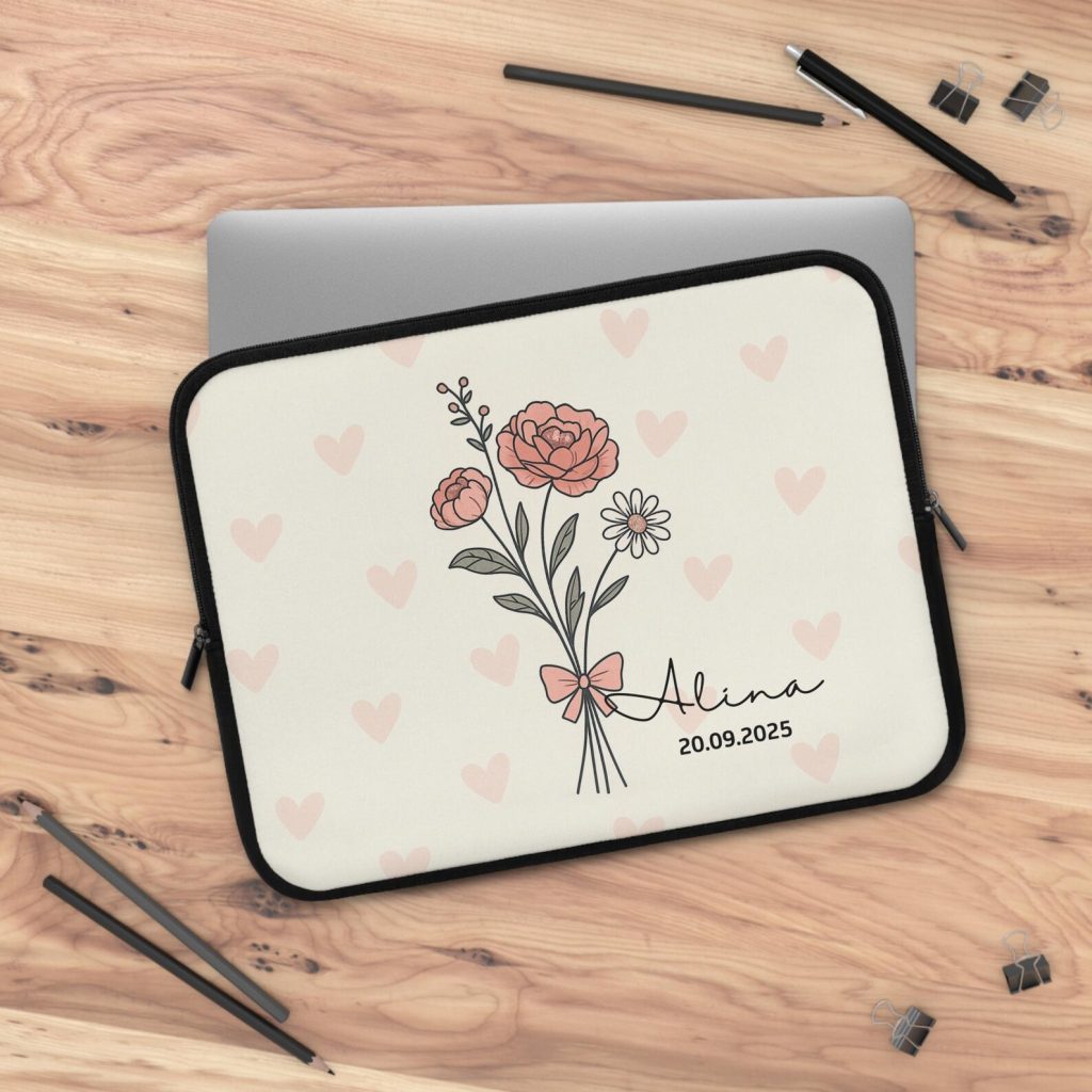 A personalized carnation birth flower laptop case with a name and date on a heart print background, a cute January birthday gift idea.