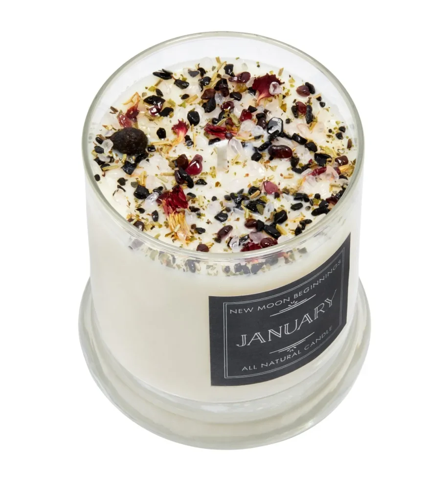 A January all natural soy candle topped with garnet crystals, dried botanicals and flower petals, a special January birthday gift idea.