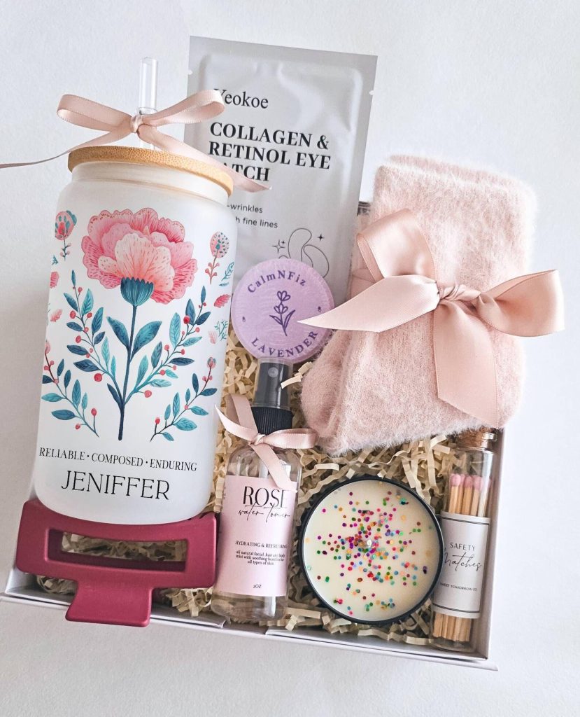 A personalized January birthday gift basket with a floral tumbler, candle, rose toner, eye patches and cozy socks.